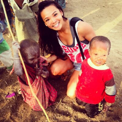 Image of Katie Liew in Africa with two Masai children in local village